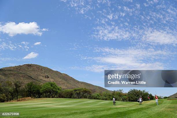 Ross Fisher of England plays his third shot into the 14th green during the third round of the Nedbank Golf Challenge at the Gary Player CC on...