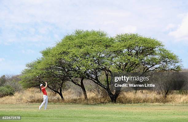Ross Fisher of England plays his third shot into the 15th green during the third round of the Nedbank Golf Challenge at the Gary Player CC on...