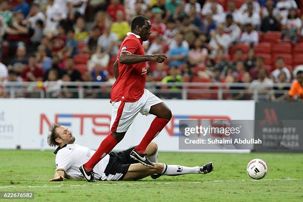 Emile Heskey of England and Jens Nowotny of Germany challenge for the ball during the Battle of Europe match between England Masters and Germany...