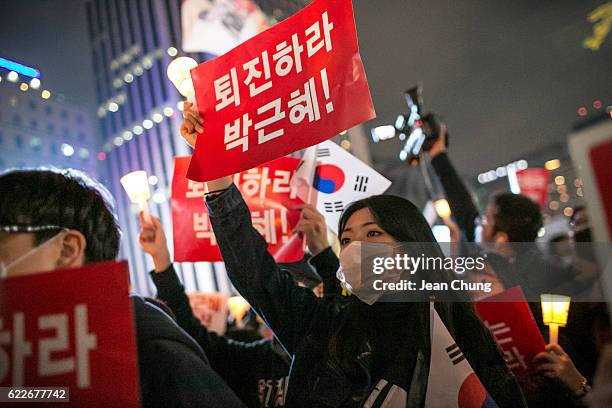 Thousands of South Koreans take to the streets in the city centre to participate in a candlelight rally to demand President Park Geun-Hye to step...