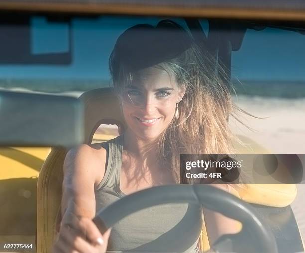 woman driving a buggy on sand dunes - dune buggy stock pictures, royalty-free photos & images