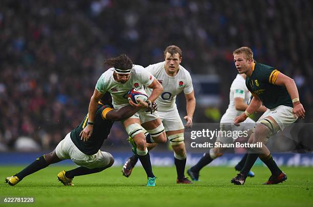 Tom Wood of England is tackled by Tendai Mtawarira of South Africa during the Old Mutual Wealth Series match between England and South Africa at...