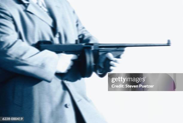 man holds machine gun - mitragliatrice foto e immagini stock