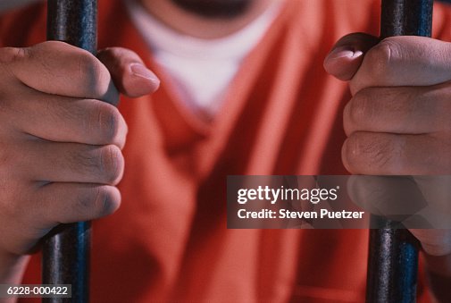Prisoner Holding Bars of Cell Prisoner Holding Bars of Cell