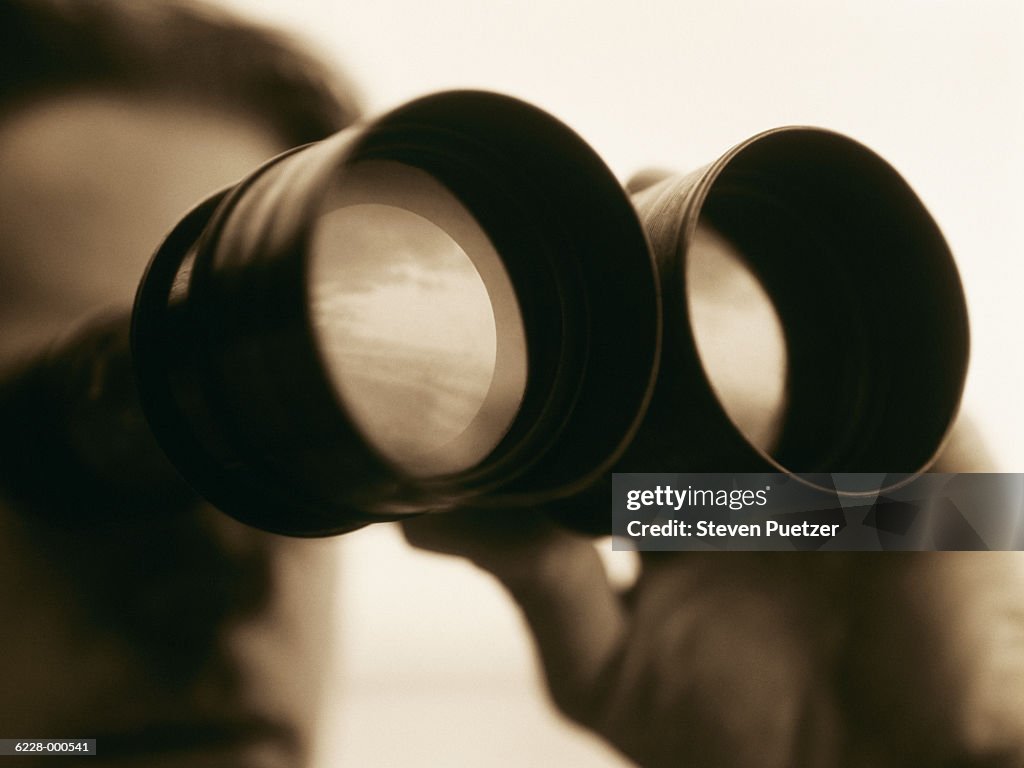 Man Looking through Binoculars