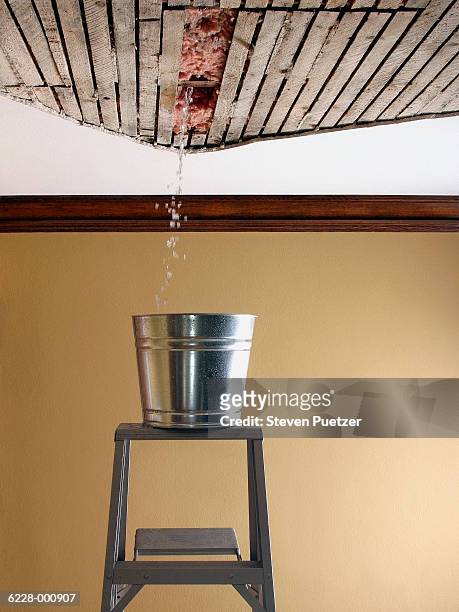 water falling from ceiling - bucket stock-fotos und bilder