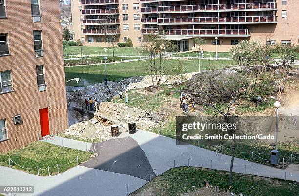 Group of African-American and Caucasian youth gather among debris on the lawn of a housing project in the Bronx, New York City, New York, 1976. .