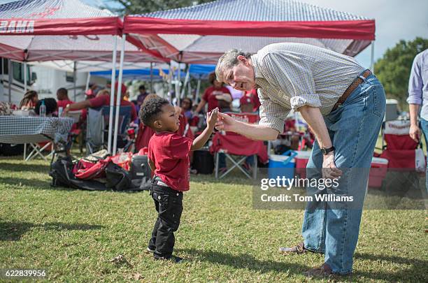 John Kennedy, Republican candidate for the U.S. Senate from Louisiana, greets a fan at a tailgate party before a football game between the Louisiana...