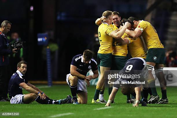 Greig Laidlaw of Scotland looks on as Reece Hodge, Nick Phipps and Tom Robertson of Australia celebrates at full time during the Scotland v Australia...