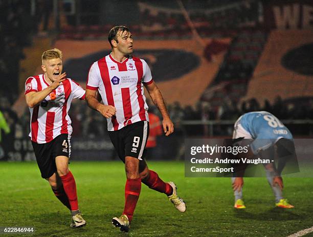 Lincoln City's Matt Rhead celebrates scoring his sides third goal during the Vanarama National League match between Lincoln City and Aldershot at...