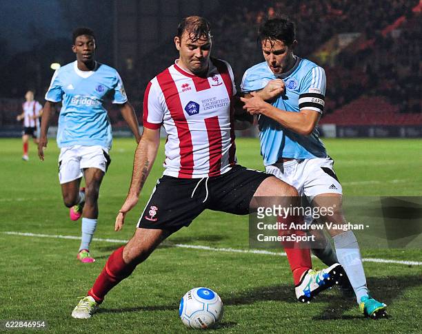 Lincoln City's Matt Rhead vies for possession with Aldershot Town's Callum Reynolds during the Vanarama National League match between Lincoln City...