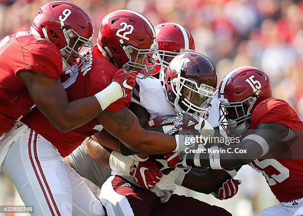 Aeris Williams of the Mississippi State Bulldogs is tackled by Da'Shawn Hand, Ryan Anderson, Joshua Frazier and Ronnie Harrison of the Alabama...