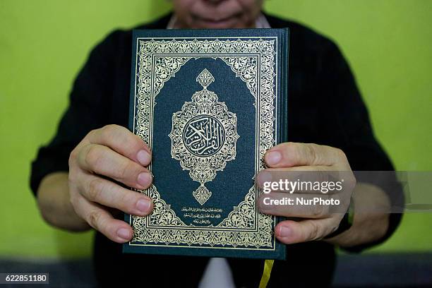 Ramdane Hadj-Idris, of Algerian origin, shows the holy book of the Quran. A small mosque in Recife, northeastern Brazil, receives Muslim immigrants...