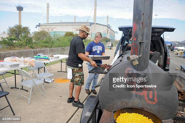 Army Black Knights fans cooking up some BBQ complete with corn in the Alamodome parking lot before the NCAA football game between the Army Black...