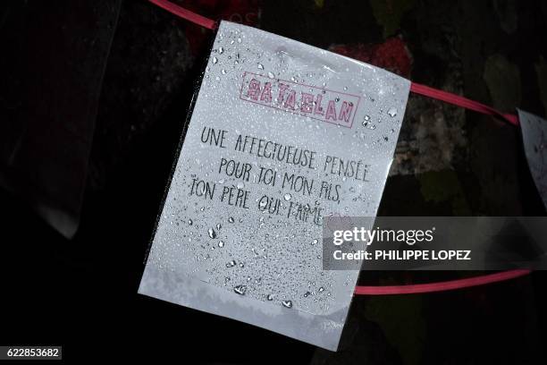 Placard reading " Bataclan. An affectionate thought for you my son, your father who loves you" is hung around a tree near the Bataclan concert hall...