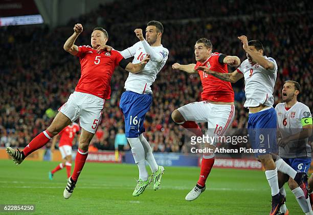 Adam Matthews of Wales, Luka Milivojevic of Serbia, Sam Vokes of Wales and Aleksandar Mitrovic of Serbia jump for a header from a Wales corner kick...
