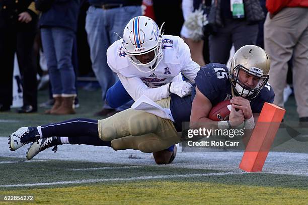 Quarterback Will Worth of the Navy Midshipmen dives into the endzone for a fourth quarter touchdown in front of Jordan Mitchell of the Tulsa Golden...