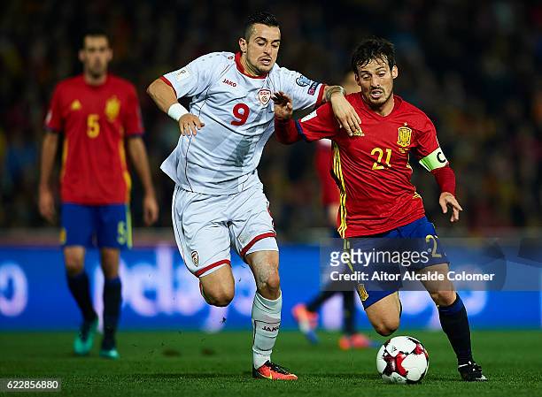 David Silva of Spain being followed by Elija Nestorovski of FYR Macedonia during the FIFA 2018 World Cup Qualifier between Spain and FYR Macedonia at...