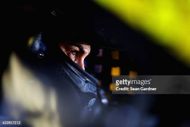 Joey Logano, driver of the Shell Pennzoil Ford, sits in his car during practice for the NASCAR Sprint Cup Series Can-Am 500 at Phoenix International...