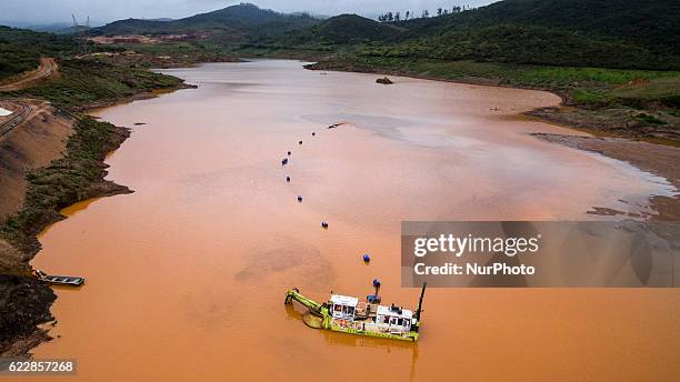 Boat carries out dredging work in flooded area by the S3 dam, built by Samarco to supposedly prevent the rest of the contaminated mud from reaching...