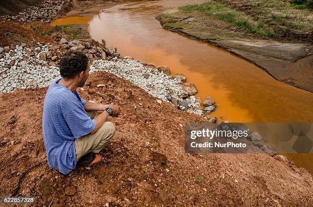 Ex-resident of Bento Rodrigues watches the construction of the S4 dam. Samarco is building in the Bento Rodrigues district - the one affected most by...