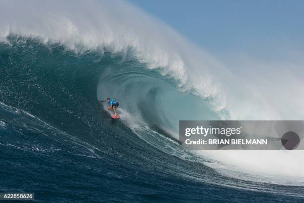 Hawaiian surfer Billy Kemper surfs a big wave at Jaws, off the coast of the Maui Island in Hawai to win the Peahi Challenge 2016, on November 11,...