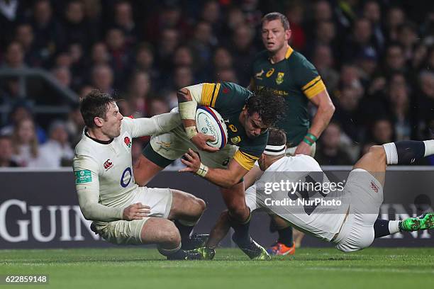 Francois Venter of South Africa charges through the tackles from Elliot Daly and Danny Care during Old Mutual Wealth Series between England and South...