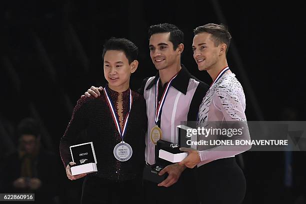 Spain's Javier Fernandez poses on the podium with second place Kazakhstan's Denis Ten and third place USA's Adam Rippon after he won the Men event at...