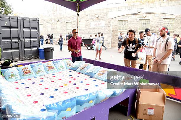 Festival goers play carnival games during day one of Tyler, the Creator's 5th Annual Camp Flog Gnaw Carnival at Exposition Park on November 12, 2016...