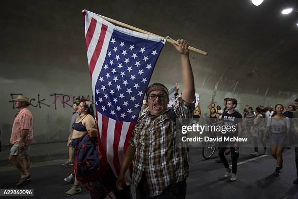 Protesters pass through a tunnel as the march in reaction to the upset election of Republican Donald Trump over Democrat Hillary Clinton in the race...