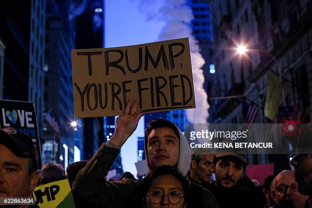 Demonstrators protest against US President-elect Donald Trump in front of Trump Tower on November 12, 2016 in New York. Americans spilled into the...