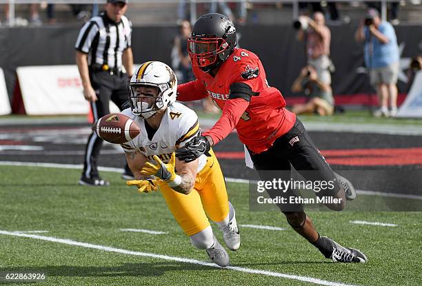 Wide receiver Tanner Gentry of the Wyoming Cowboys catches a 50-yard pass against defensive back Kenny Keys of the UNLV Rebels during their game at...