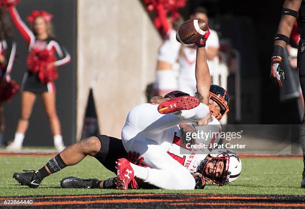 After safety Jordan Sterns of the Oklahoma State Cowboys tackled wide receiver Derrick Willies of the Texas Tech Red Raiders, Willies shows he caught...