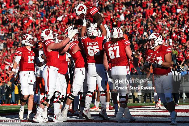 Corey Clement of the Wisconsin Badgers celebrates a touchdown with teammates during the first half of a game against the Illinois Fighting Illini at...