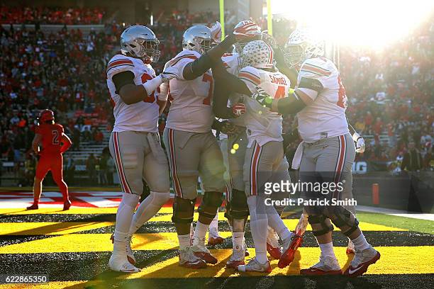 Running back Curtis Samuel of the Ohio State Buckeyes celebrates with teammates after scoring a touchdown against the Maryland Terrapins in the first...