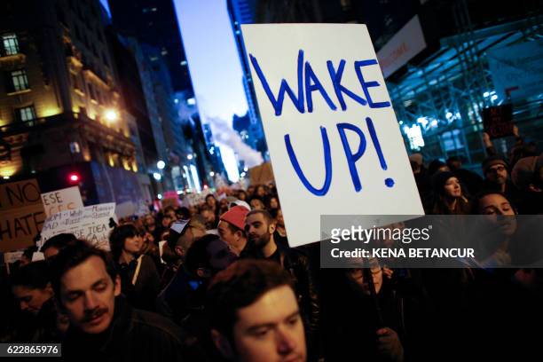 Demonstrators protest against US President-elect Donald Trump in front of Trump Tower on November 12, 2016 in New York. Americans spilled into the...