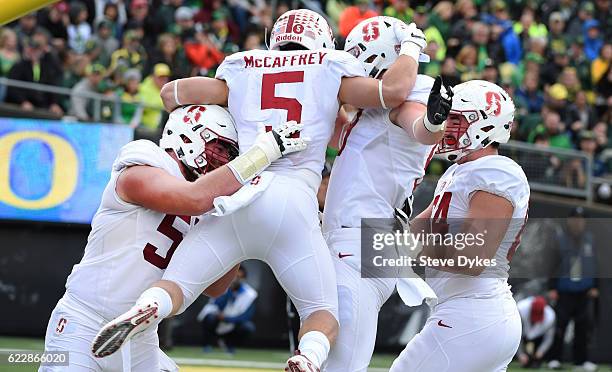 Running back Christian McCaffrey of the Stanford Cardinal celebrates with teammates after scoring a touchdown during the first quarter of the game...