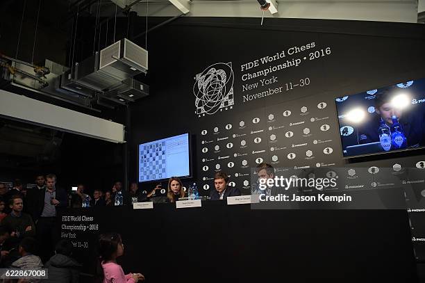 Press Officer Anastasia Karlovich, Chess grandmaster Sergey Karjakin and Reigning Chess Champion Magnus Carlsen speak at a press conference after a...