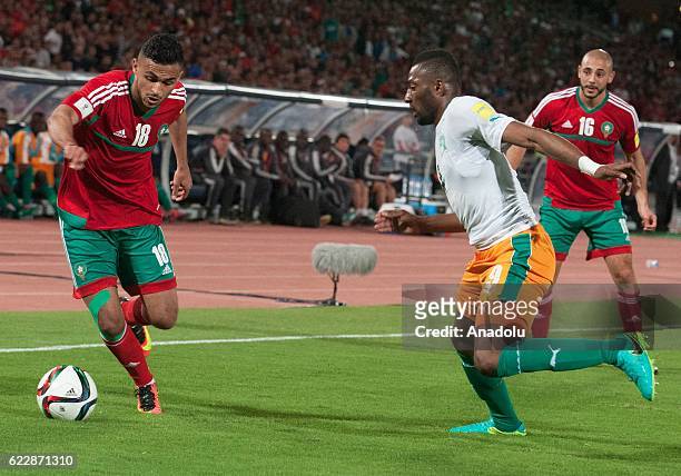 Sofiane Boufal of Morocco vies with Wilfried Kanon of Ivory Coast receives a treatment during the 2018 World Cup qualifying Group C football match...