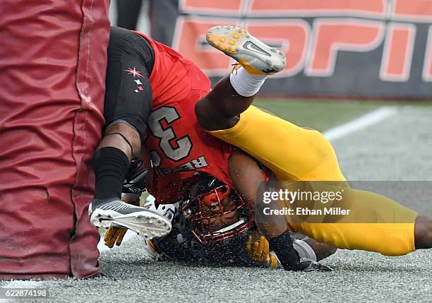 Defensive back Jericho Flowers of the UNLV Rebels slams into the goal post after he caught a touchdown pass in the first overtime against cornerback...