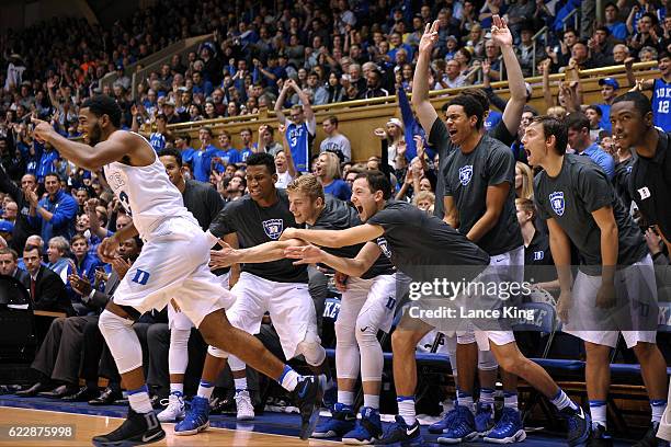 Duke players react from their bench following a basket by Matt Jones of the Duke Blue Devils during their game against the Grand Canyon Antelopes at...