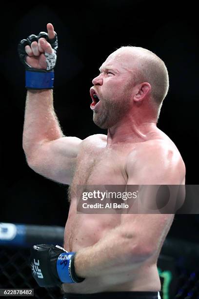 Tim Boetsch of the United States celebrates his victory by KO over Rafael Natal of Brazil in their middleweight bout during the UFC 205 event at...