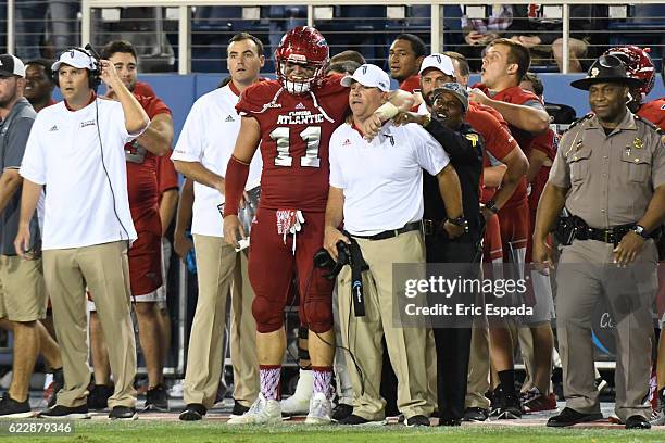 Trey Hendrickson of the Florida Atlantic Owls hugs Head Coach Charlie Partridge after they defeated the UTEP Miners at FAU Stadium on November 12,...