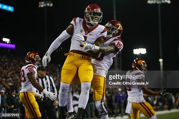 Wide receiver Darreus Rogers of the USC Trojans is congratulated by wide receiver Deontay Burnett after scoring a touchdown against the Washington...
