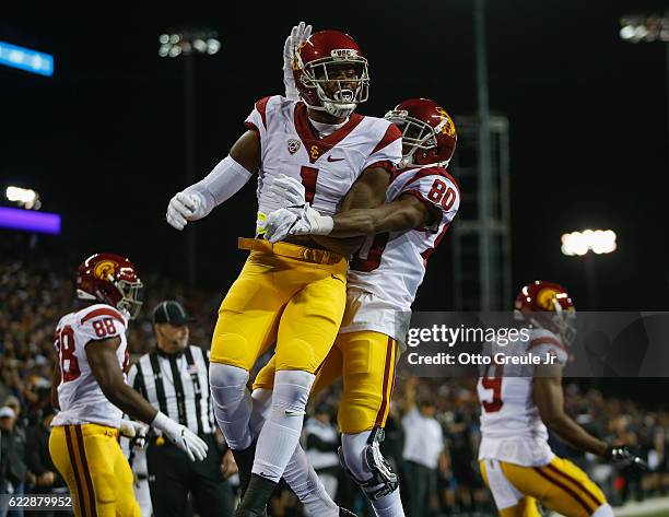 Wide receiver Darreus Rogers of the USC Trojans is congratulated by wide receiver Deontay Burnett after scoring a touchdown against the Washington...