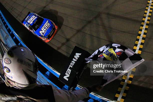 Kyle Busch, driver of the NOS Energy Drink Toyota, takes the checkered flag to win the NASCAR XFINITY Series Ticket Galaxy 200 at Phoenix...