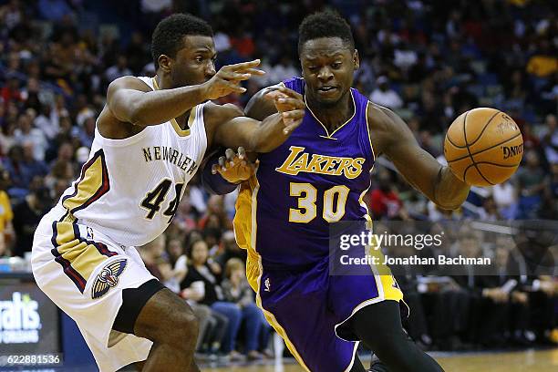 Julius Randle of the Los Angeles Lakers drives against Solomon Hill of the New Orleans Pelicans during the second half of a game at the Smoothie King...