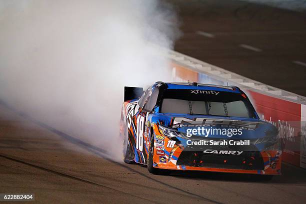 Kyle Busch, driver of the NOS Energy Drink Toyota, celebrates with a burnout after winning the NASCAR XFINITY Series Ticket Galaxy 200 at Phoenix...