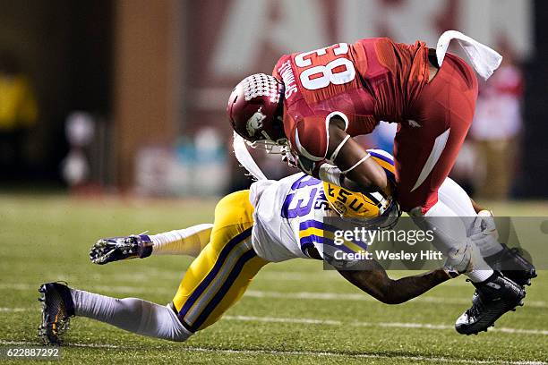 Jeremy Sprinkle of the Arkansas Razorbacks is tackled after catching a pass by Jamal Adams of the LSU Tigers at Razorback Stadium on November 12,...