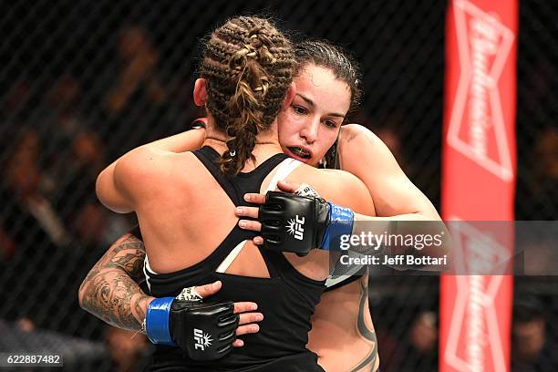 Miesha Tate of the United States embraces Raquel Pennington of the United States after her unanimous decision defeat in their women's bantamweight...